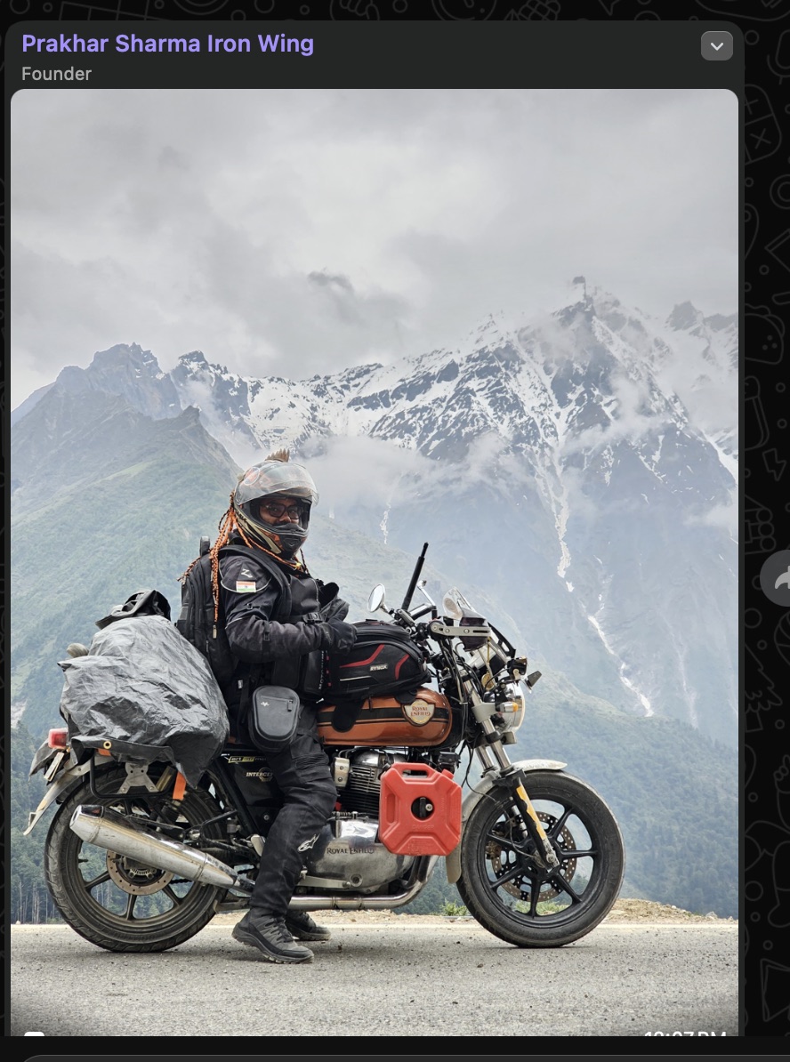 Iron Wings rider with motorcycle in mountain terrain